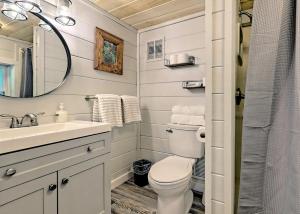 a bathroom with a toilet and a sink and a mirror at Cute n Chic in Clayton in Clayton +28 photos