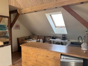 a kitchen with a counter top in a room at Apartament 2-pokojowy, z atrakcjami dla dzieci in Kolonia Salnia