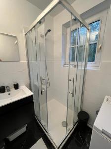 a bathroom with a shower and a sink at Belle maison en pierre, grand jardin au calme in Rocquemont +19 photos
