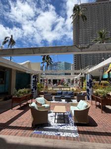 a patio with chairs and a table and buildings at Central YMCA Residences in Honolulu