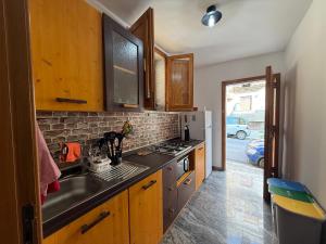 a kitchen with a sink and a stove at LightHouse - Casa di Luce in Reggio di Calabria
