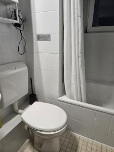 a white bathroom with a toilet and a shower at Ferienwohnung Daliah in Wangels