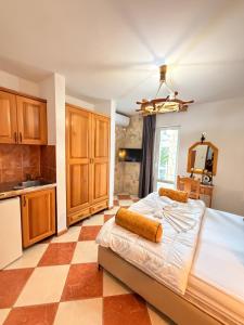 a bedroom with a large bed and a kitchen at Wiena Apartments in Ulcinj