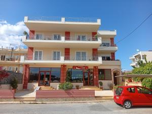 a red car parked in front of a building at Skala Central Comfort Apartment in Skála