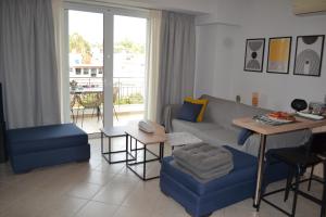a living room with a couch and a table at Skala Central Comfort Apartment in Skála