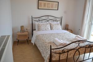 a bedroom with a large bed with a black frame at Skala Central Comfort Apartment in Skála