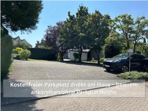 a parking lot with a car parked in a driveway at Ruhige Ferienwohnung Seemöwe mit Balkon - ideal für Paare & Radurlauber in Radolfzell am Bodensee