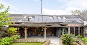 a house with solar panels on the roof at Vacation at Emi's in Wetteren