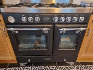 a black stove with an open oven in a kitchen at Vacation at Emi's in Wetteren