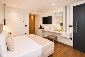a hotel room with a bed and a sink at Nobile Boutique Hotel in Agios Gordios