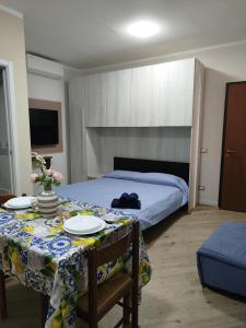 a bedroom with a bed and a table with plates on it at Mono perfetto per Ospedale e Treni Check-in rapido in Livorno