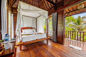 a bedroom with a canopy bed on a porch at Escape To Paradise With Private Pool in Silebeng