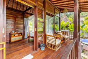 a porch of a wooden house with a pool at Escape To Paradise With Private Pool in Silebeng