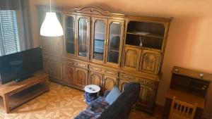 a living room with a large wooden hutch at Casa Lameiro in Cedeira