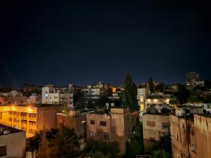 a view of a city at night at Friends Hotel Jordan in Amman +102 photos