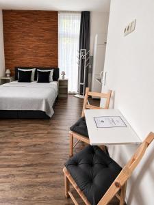 a bedroom with a bed and a table and a chair at GuestNest-Erfurt in Erfurt