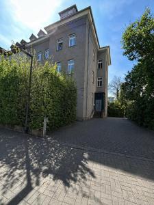 a large brick building with a driveway in front of it at GuestNest-Erfurt in Erfurt