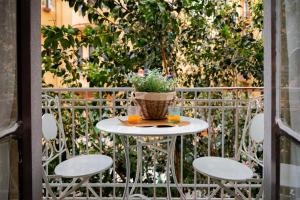 a table with two glasses and a potted plant on it at B&B ELEGANT LENA in Salerno