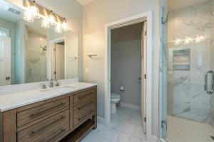 a bathroom with a sink and a shower and a toilet at Lake Walk Cottage in Black Mountain +31 photos