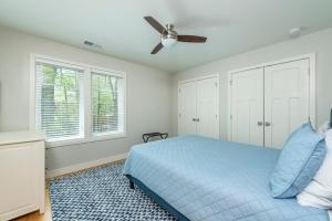 a bedroom with a blue bed and a ceiling fan at Lake Walk Cottage in Black Mountain