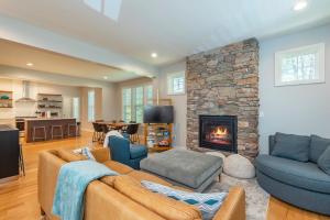a living room with a couch and a fireplace at Lake Walk Cottage in Black Mountain