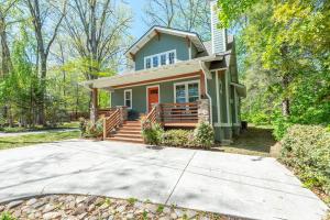a house with a driveway in front of it at Lake Walk Cottage in Black Mountain