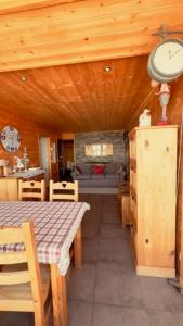 a dining room with a table and a couch at « Le doux Chalet » Roche Béranger in Chamrousse