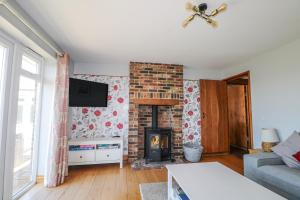 a living room with a fireplace and a tv at 50 Harbour Road in Bognor Regis