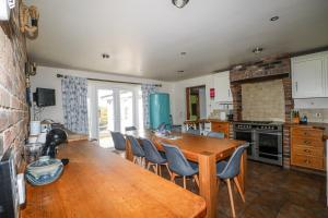 a kitchen with a wooden table and chairs at 50 Harbour Road in Bognor Regis