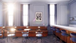 a rendering of a restaurant with a couch and chairs at Hotel Orlo in Greensboro