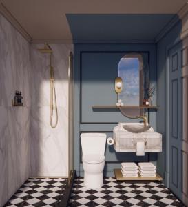 a bathroom with a toilet and a mirror at Hotel Orlo in Greensboro