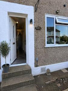 a door to a house with a window and stairs at Cosy Double Room in London Free Parking Private Bathroom Close to Transport in Belvedere