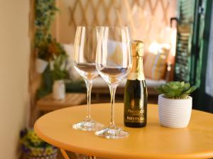 two wine glasses and a bottle of champagne on a table at Casa Sole - holiday apartment in Maccagno Superiore