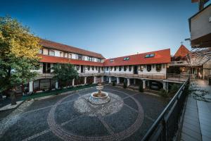 a courtyard in a town with a fountain at Apartmány Reduta - new in Lučenec