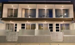 a building with white doors and windows at Shalos Studios - Cozy Central in Ayia Napa