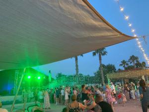 a crowd of people standing in front of a stage at Mobilhome au Camping La Yole in Vendres +26 photos