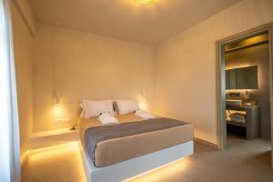 a bedroom with a bed in a small room at Onar Hotel Kimolos in Kimolos