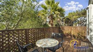 a patio with a table and chairs on a deck at Casa Rio Del Mar in Aptos