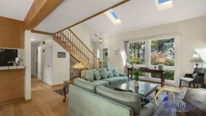 a living room with a couch and a table at Casa Rio Del Mar in Aptos