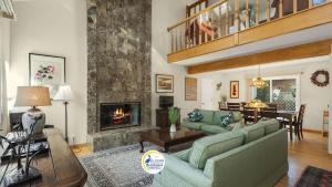 a living room with a couch and a fireplace at Casa Rio Del Mar in Aptos +25 photos