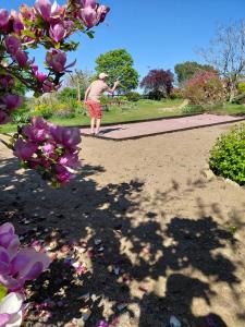 a man walking down a path in a park at Les Bienfaits d'Harmonium in La Chapelle-Gaudin
