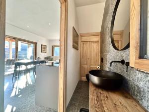 a bathroom with a black bath tub and a mirror at Perla di Mergozzo 1 in Mergozzo