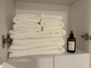 a pile of towels on a shelf in a bathroom at Depto Monroe 2 in Buenos Aires +25 photos