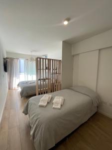 a bedroom with two beds with towels on it at Depto Monroe 2 in Buenos Aires