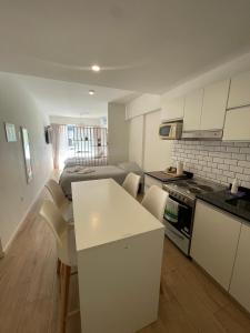 a kitchen and living room with a table and chairs at Depto Monroe 2 in Buenos Aires