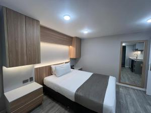 a hotel room with a bed and a mirror at ApartaSuite City Bog Usaquén in Bogotá +16 photos