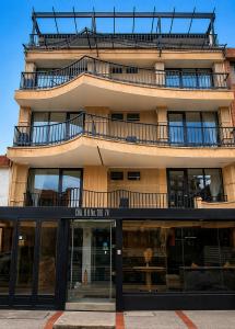 a tall building with a balcony on top of it at ApartaSuite City Bog Usaquén in Bogotá