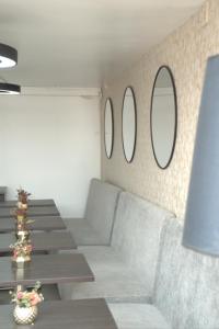 a living room with a couch and mirrors on the wall at ApartaSuite City Bog Usaquén in Bogotá