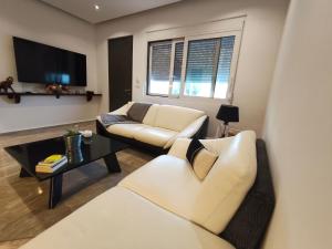 a living room with a couch and a table at Sunrise House in Kefalos