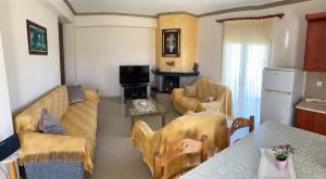 a living room with a couch and a table at SONIA in Kallithea Halkidikis